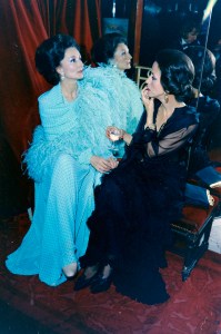 Comtesse Jacqueline de Ribes in a turquoise georgette Dior evening ensemble sits with socialite Gloria Guinness in black St. Laurent chiffon during businessman Robert Mahoney's private party at Maxim's de Paris during the Battle of Versailles events on Nov. 26, 1973.